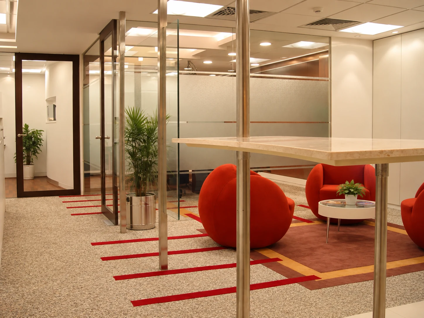 Office breakout area with glass partitions, fitted counters and lounge seating