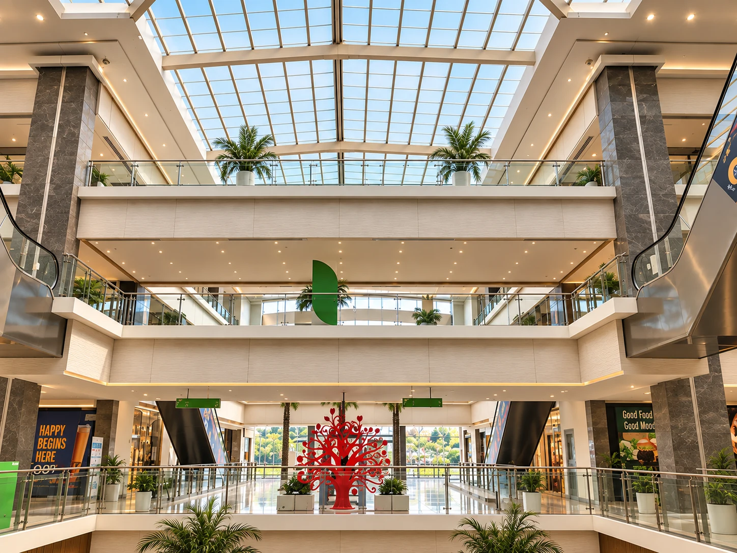Daylit shopping mall atrium with landscaped seating and glazed roof